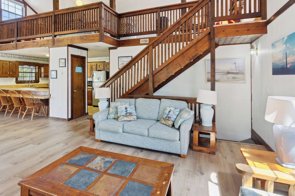 Relax in the spacious Living Area with a large, Flat Screen TV and lots of cozy furniture.