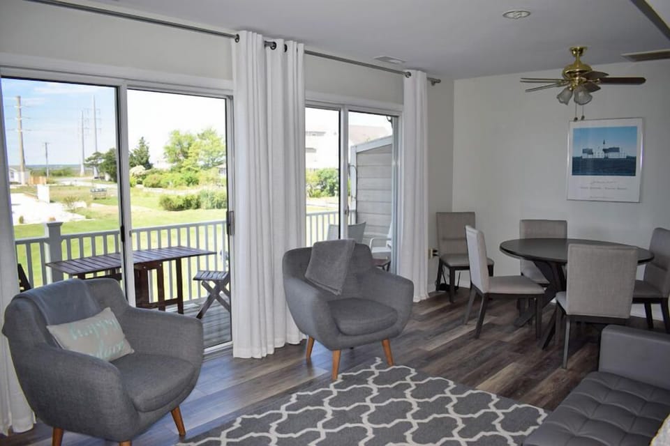 Full wall of sliding doors that open to a large waterfront balcony