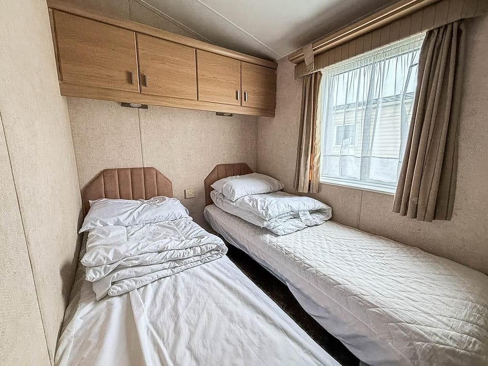 Cozy twin bedroom with natural light and ample storage