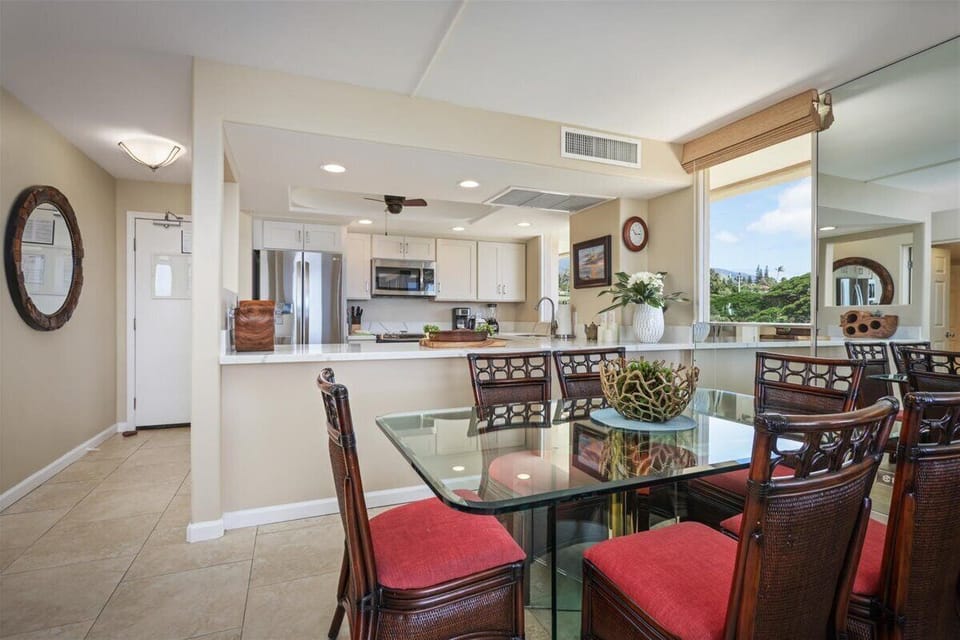 Your open-concept living space flows seamlessly from dining to kitchen, with lush garden views framing every meal. Natural light fills the airy room, while modern amenities await your island breakfast prep.