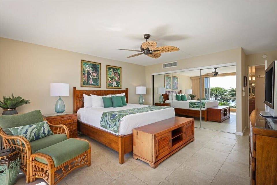 Unwind in your tropical retreat with crisp linens, warm wood tones, and calming green accents that invite you to relax after a day of adventure.