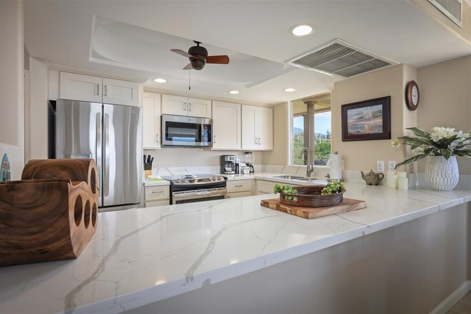Gather around this bright, open kitchen with sparkling countertops, modern appliances, and everything you need to prepare your favorite meals together.