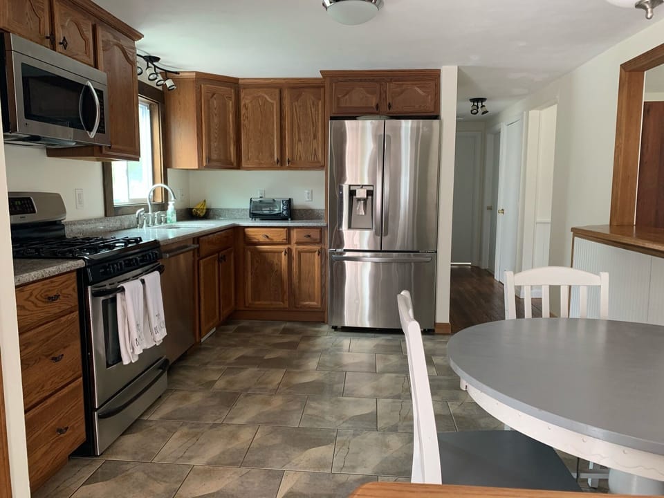 Kitchen with Stainless steel appliances and fridge with icemaker