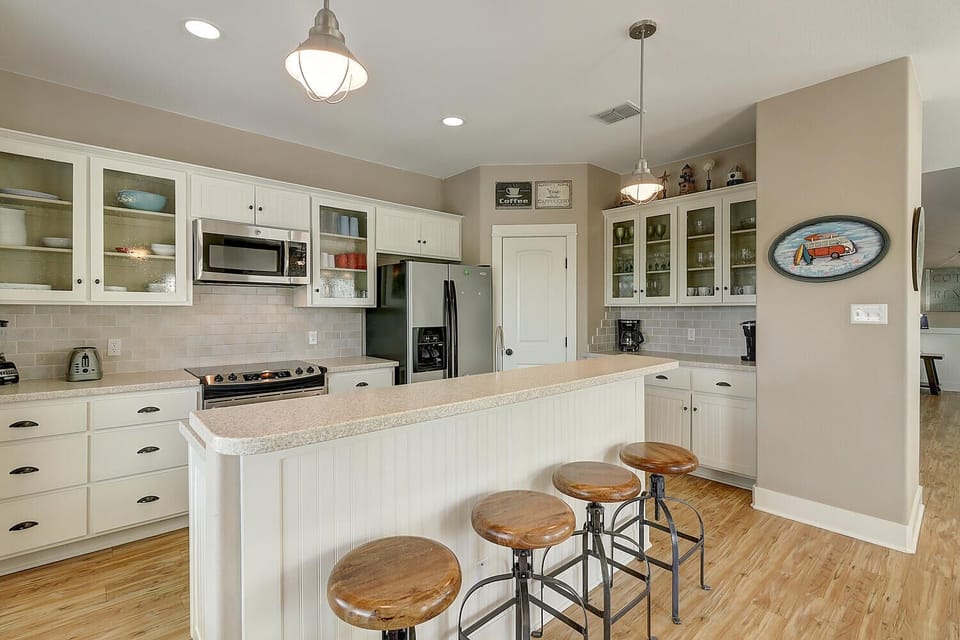 Your gourmet kitchen awaits with granite counters, stainless appliances, and a breakfast bar where morning coffee tastes even better.