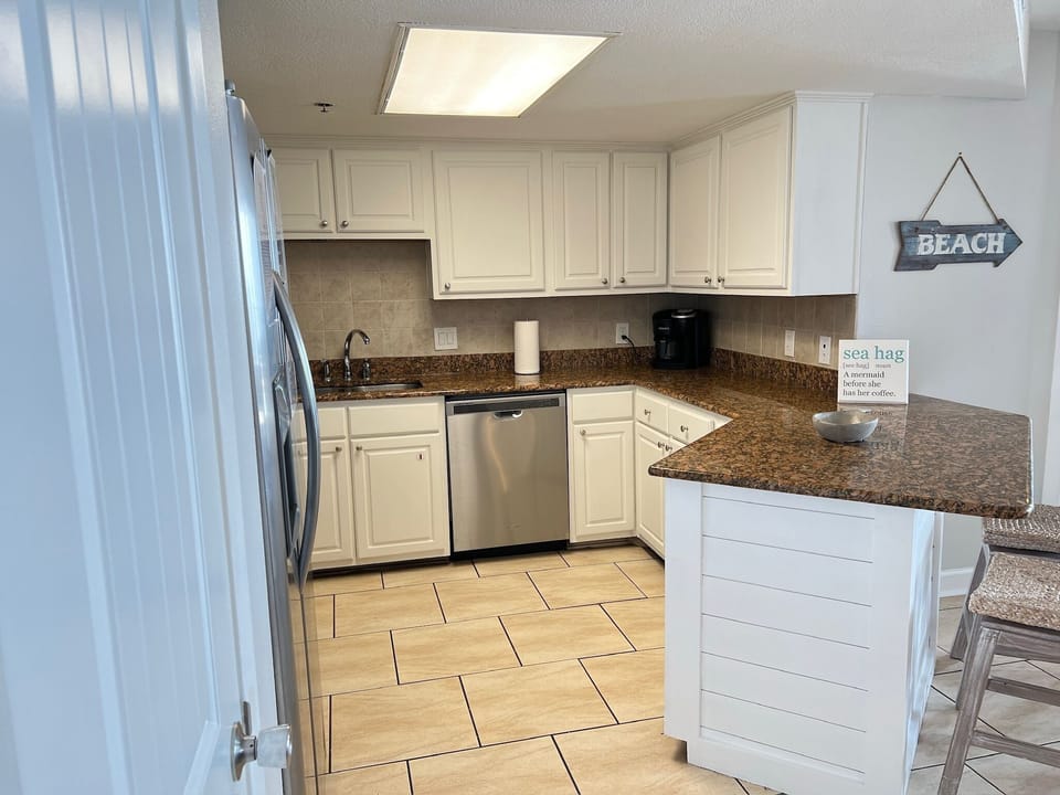 Kitchen with all the essentials such as pots, pans, cooking utensils, plates, and glassware.  Also included are coffee maker, toaster, blender, air fryer, and a mixer