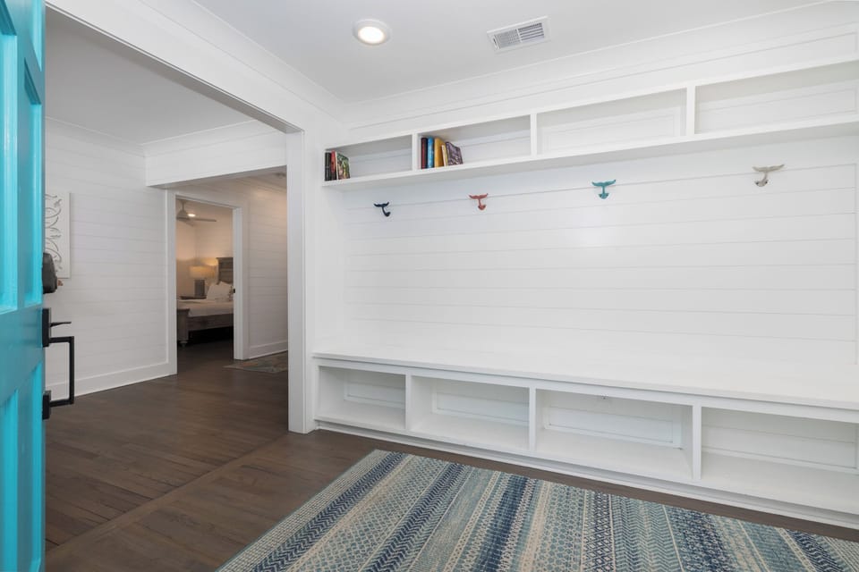 A welcoming entryway with built-in storage benches greets you