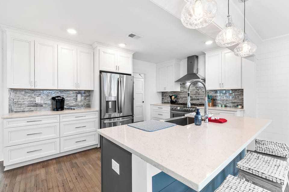 Your fully equipped kitchen comes with a professional-grade gas range, stylish backsplash, and elegant lighting