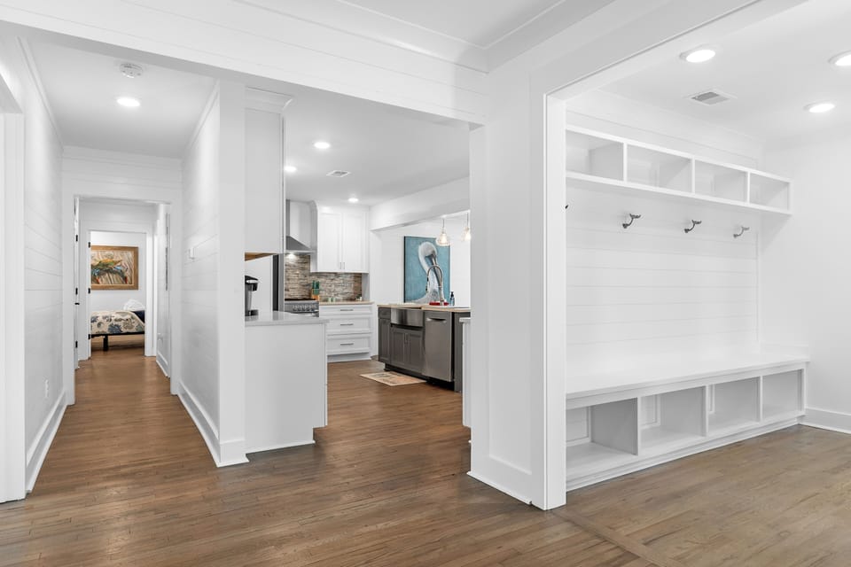 The entryway welcomes you with a built-in storage bench and coat hooks