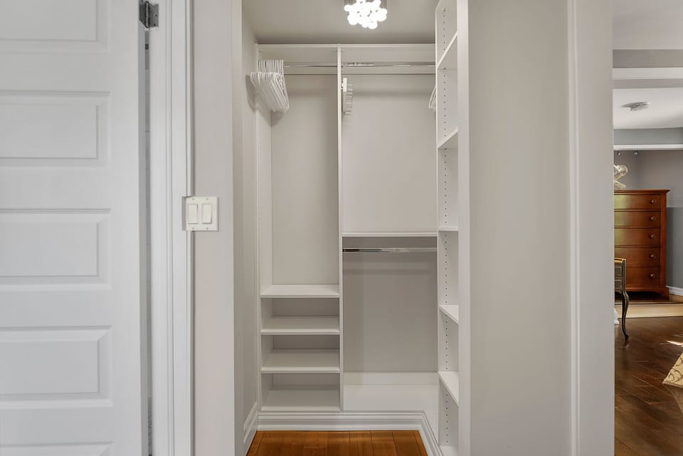 Primary bedroom has a large walk-in closet to unpack and store suitcases. The Rosette House in Old Town Niagara-on-the-Lake