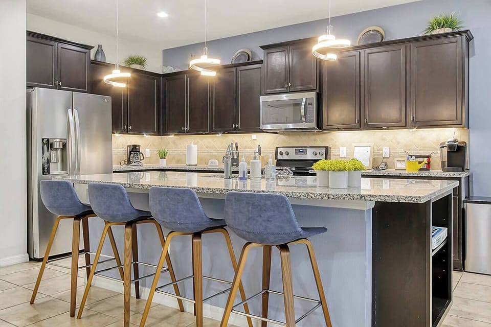 Spacious, modern kitchen with granite counter tops, brand new stainless steel appliances and lots of lighting.