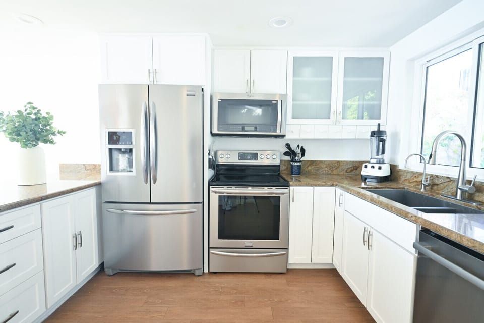 The well-appointed kitchen includes high-end appliances like a Vitamix blender and a stainless steel Angel juicer. Cheers to your health!