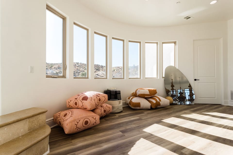 Yoga room with pillows and mats.