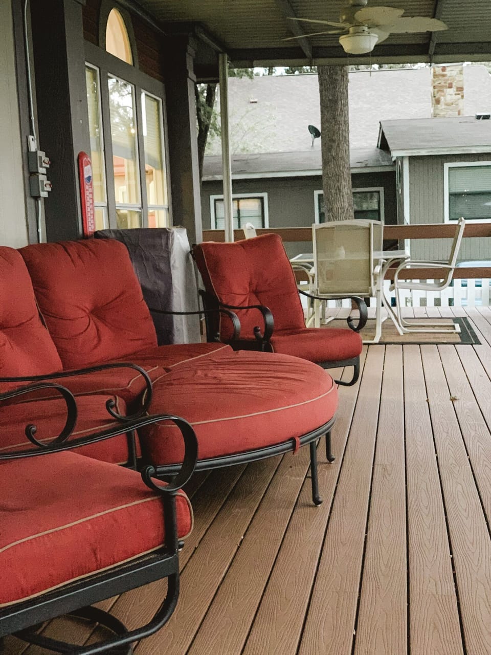 The large deck is complete with oversized furniture.
