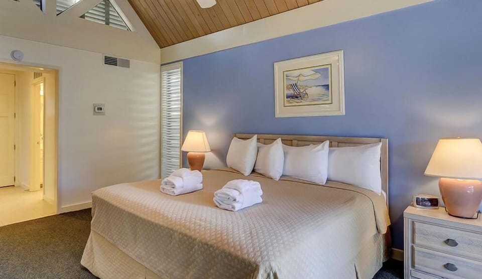 Sink into plush bedding beneath vaulted ceilings and soft lighting.