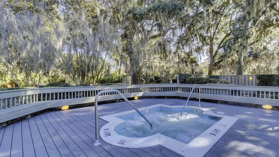 Unwind in the secluded hot tub surrounded by tranquil trees.