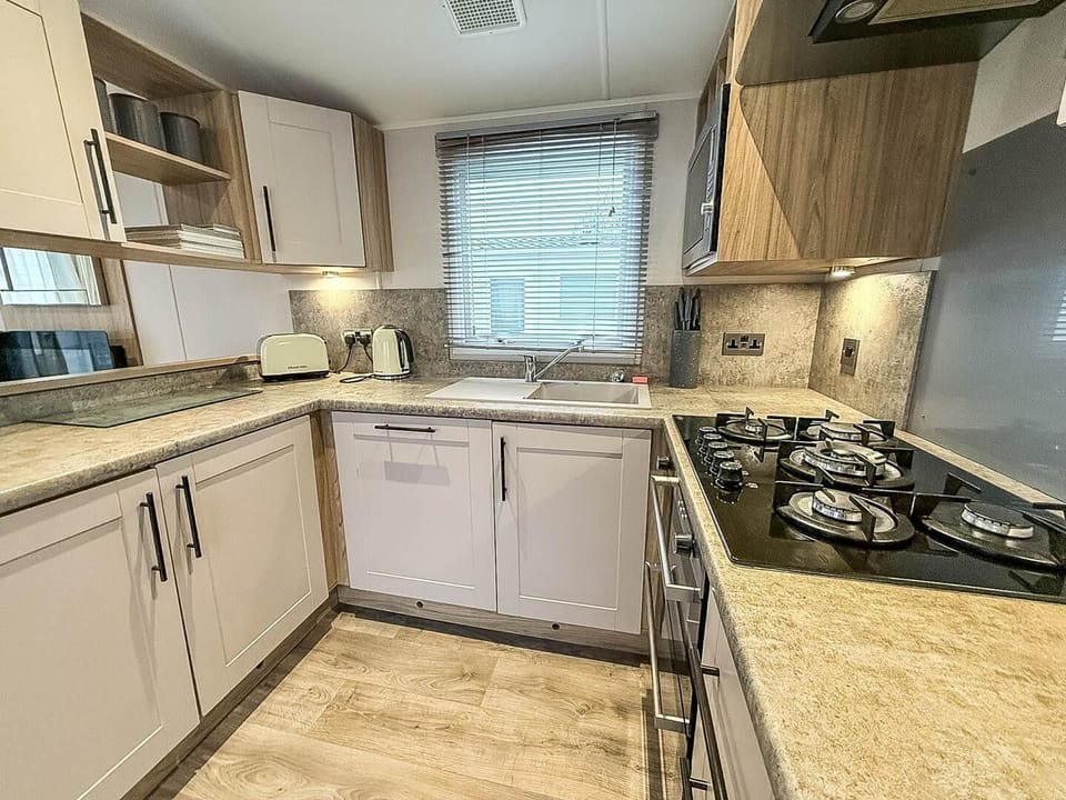 Enjoy the convenience of a comfortable kitchen area of a caravan during your stay at Pakefield Holiday Park, located in the picturesque Pakefield, Suffolk, UK.