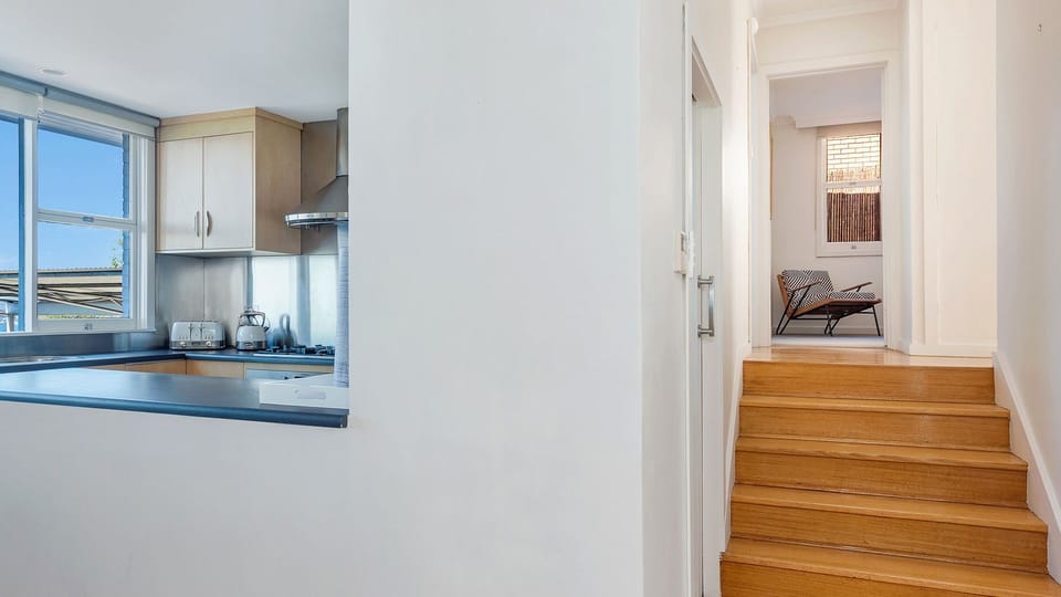 5 Stairs leading to the upper level from the entry level. Ducted heating panel is on the left side of wall.