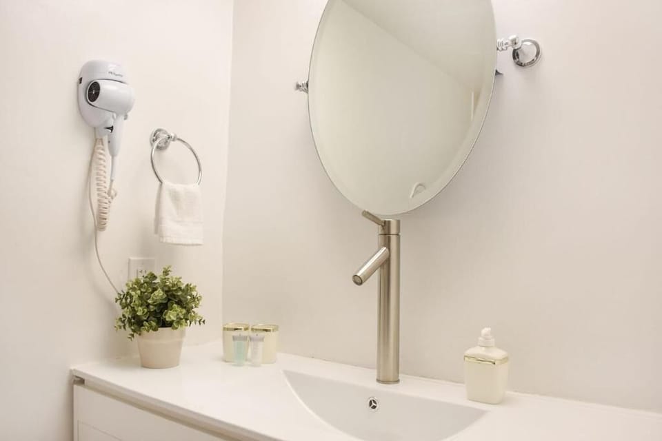 Refresh at the sleek vanity with bright, spa-like simplicity.
