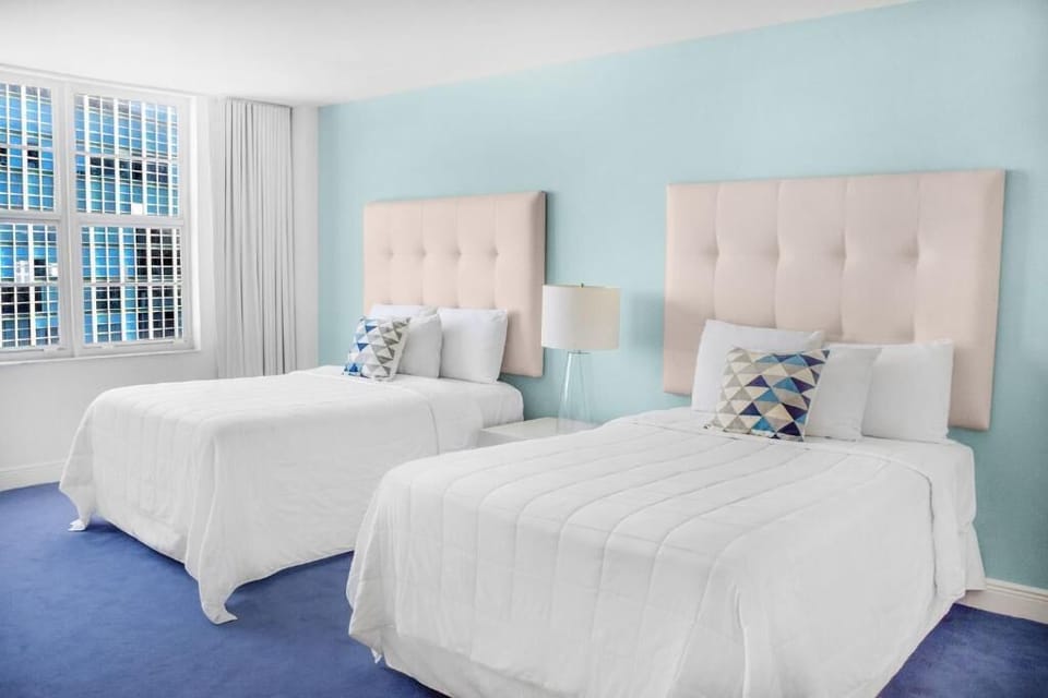 Drift off in crisp beds under soft, calming colors.