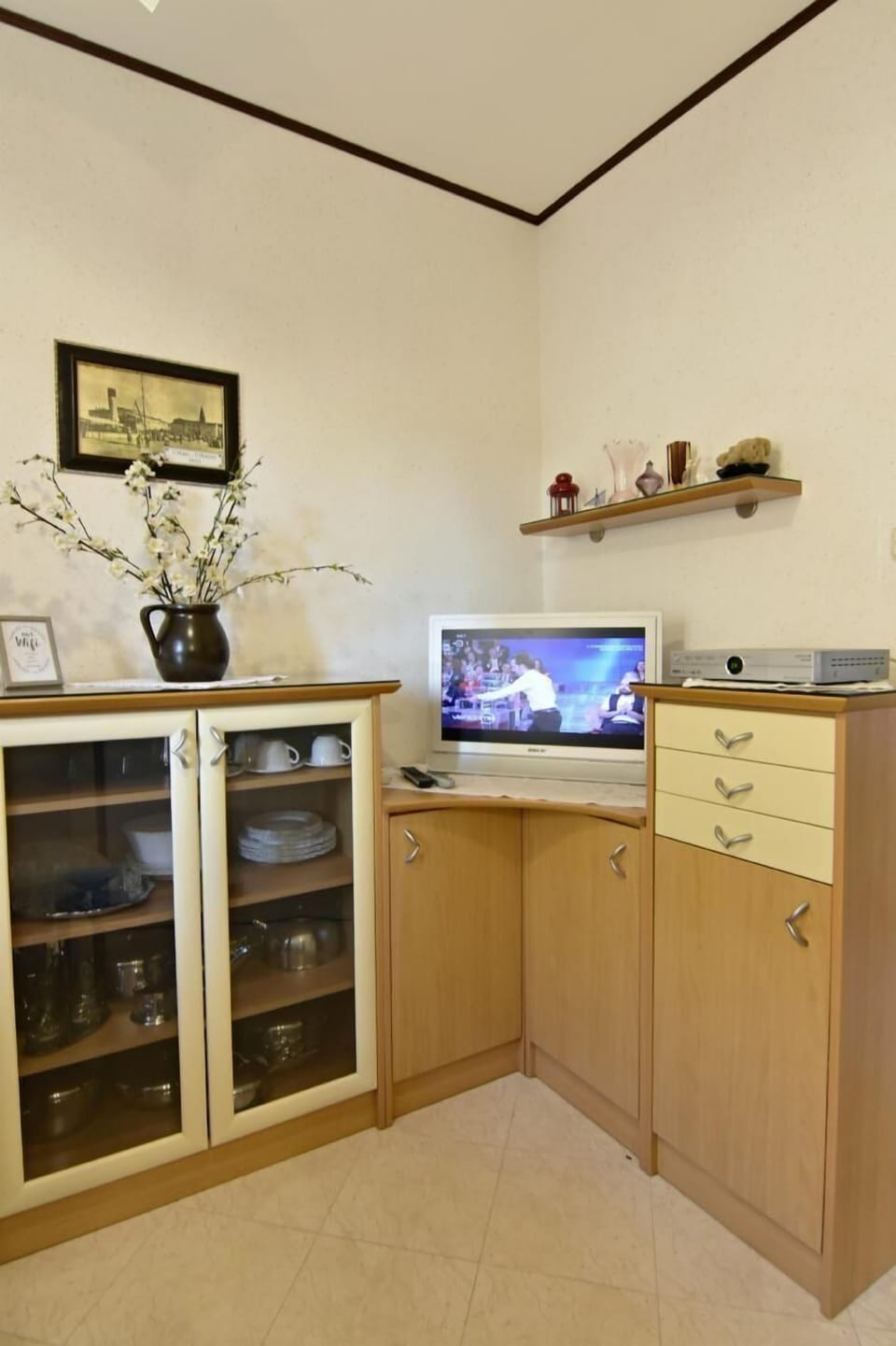 The TV cabinet, dresser and flat screen satellite TV.