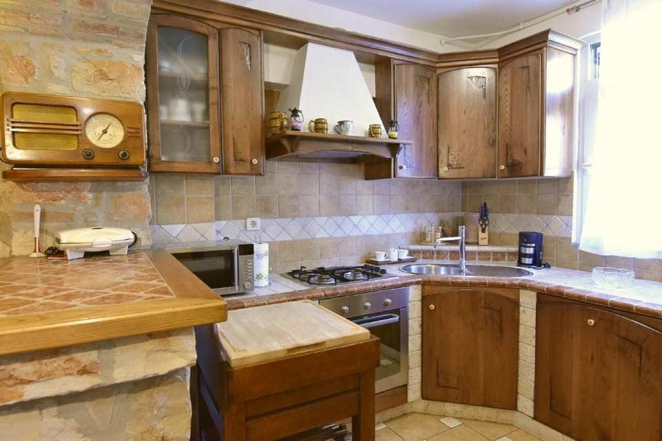 The kitchen equipped with dishwasher, microwave, kettle, oven.