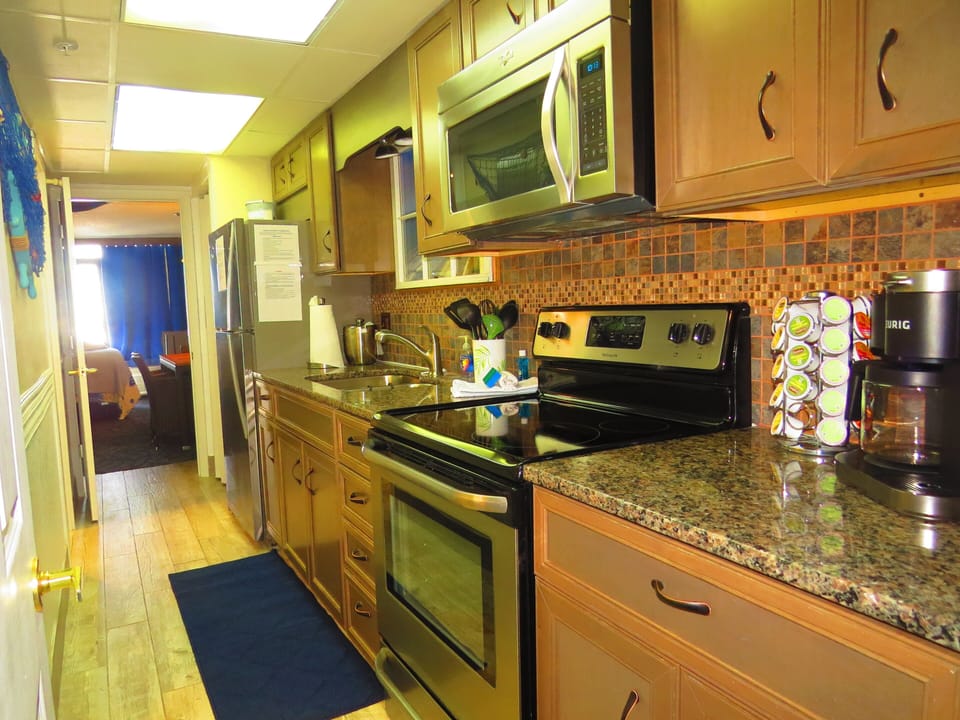 Fully Stocked Galley Style Kitchen with all stainless steel appliances. 