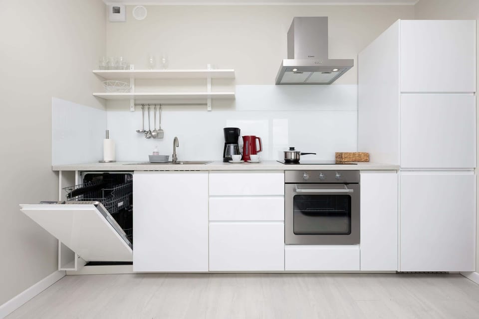 Kitchenette with oven and refrigerator. 
