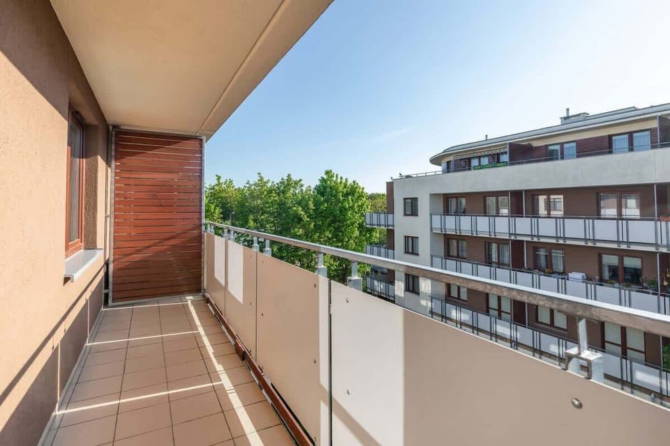 Furnished balcony with green surroundings. 