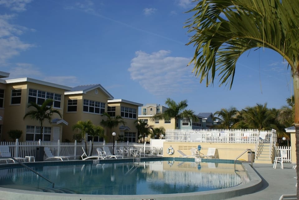 Unwind poolside in a quiet courtyard framed by palms.