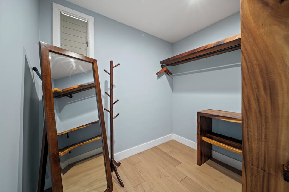 Keep everything tidy with a dedicated storage area offering open shelving and hanging space.