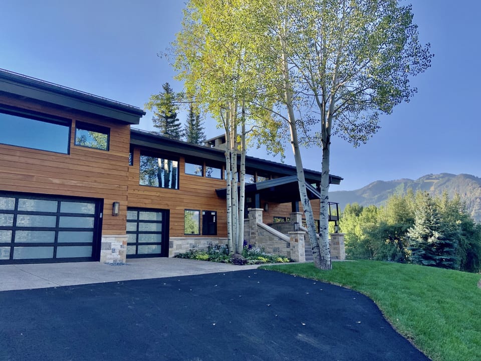 Two car garage with third bay acting as mudroom for skies/bikes and sauna
