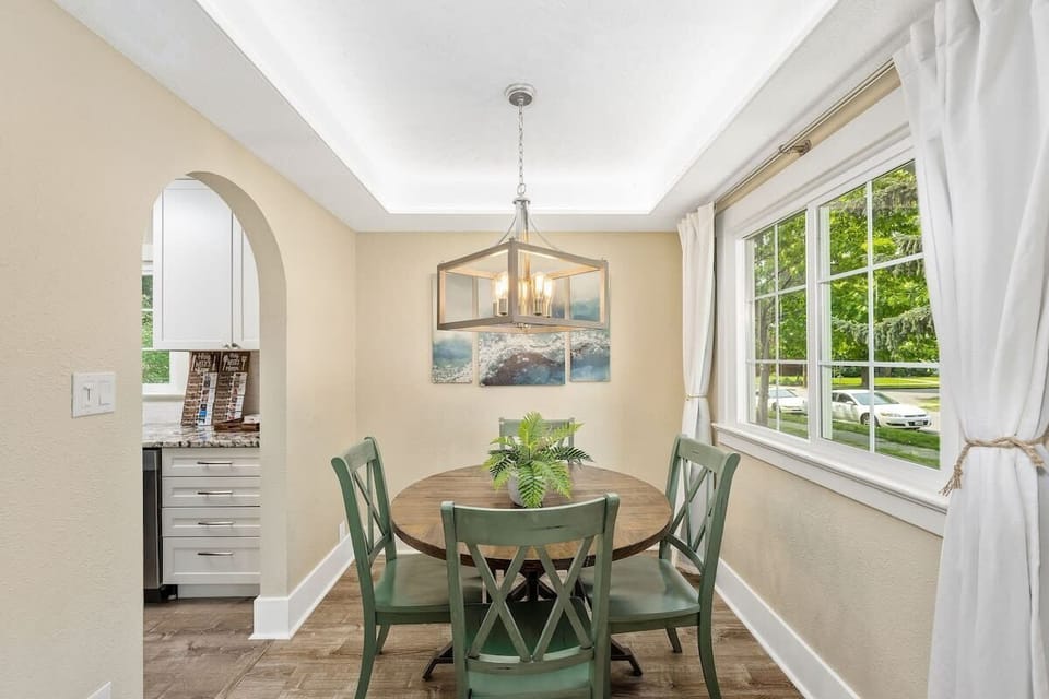 Gather around this charming dining space where natural light streams through large windows, creating the perfect setting for your morning coffee or evening meals.