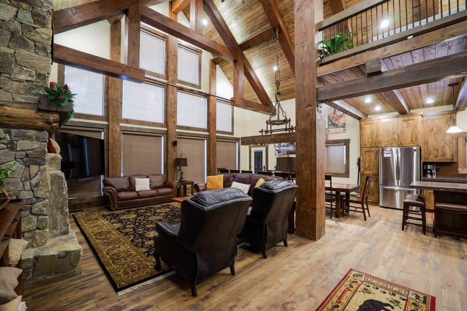 Large family room with 85 inch tv and leather couches. Dining table that seats 20 people. 