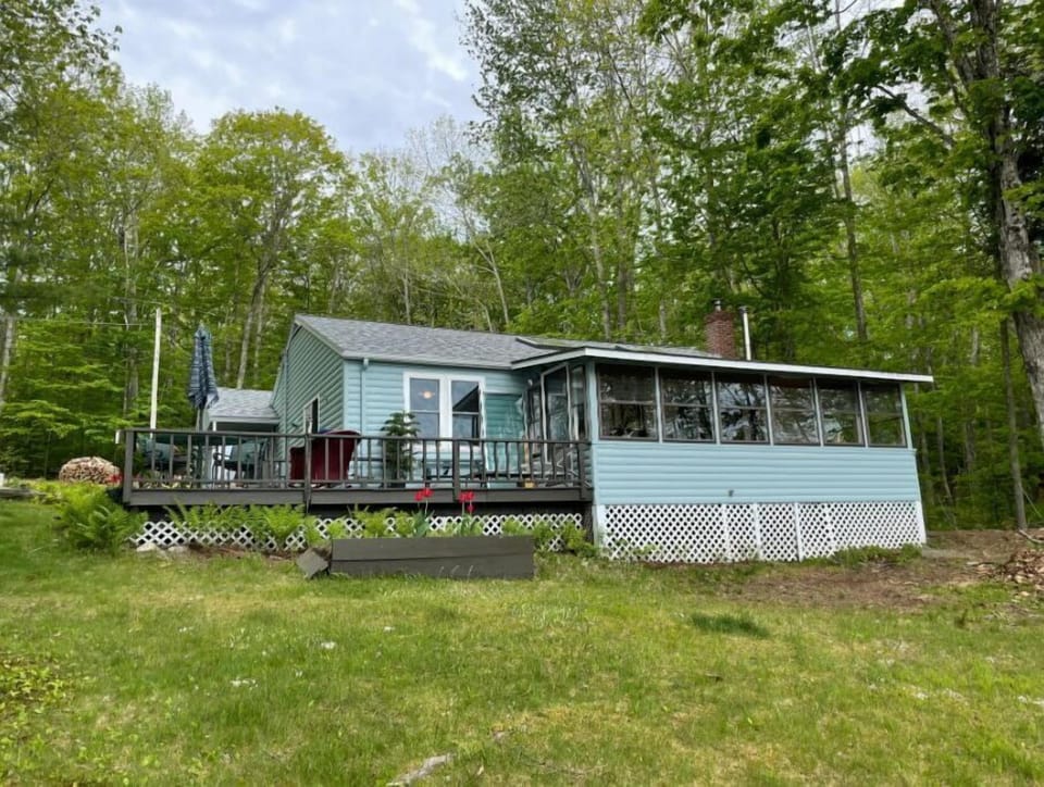 Deck with dining table, grill and glass/screen porch for retreating if it rains.