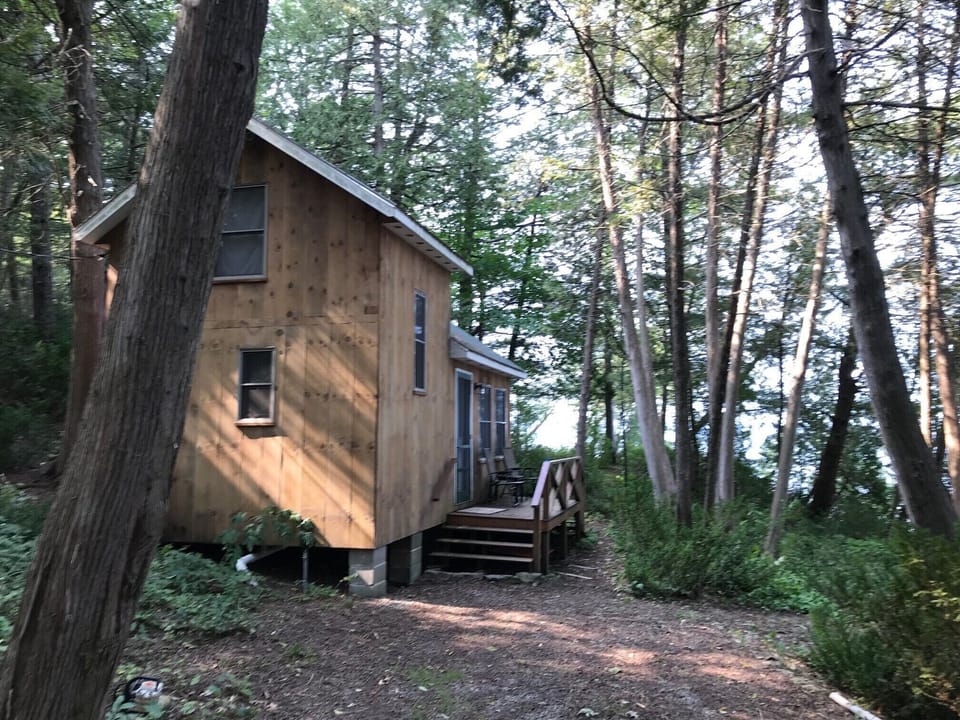 The cottage is close to the lake, tucked underneath mature cedar trees. 