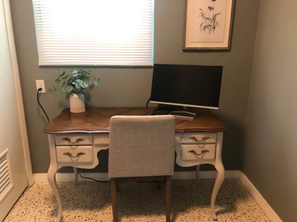 Private workspace – Dedicated desk, monitor & chair for remote work.