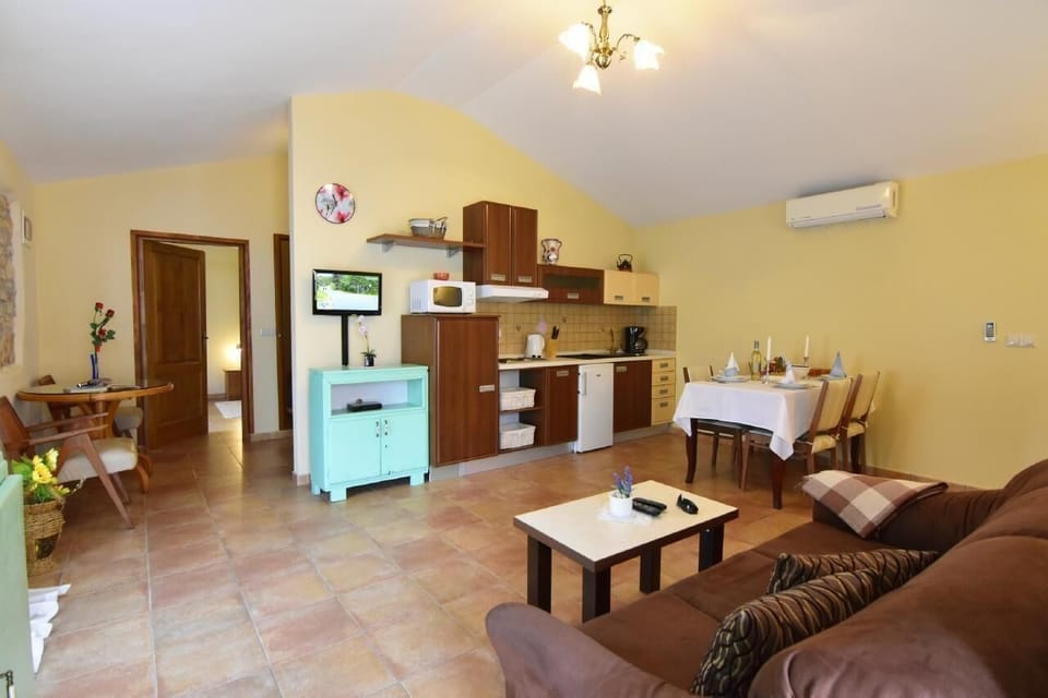 The living area with sofa bed, coffee table, satellite TV, dining table.