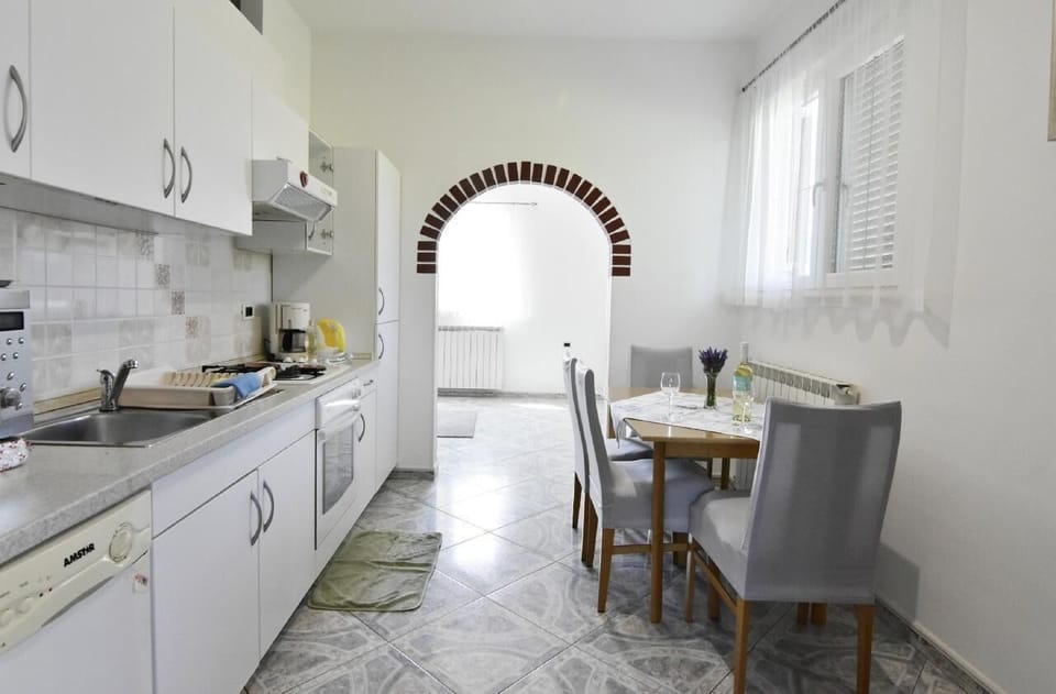 The kitchen with dining table and chairs.