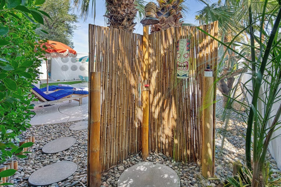 Tiki inspired and secluded outdoor shower for rinsing