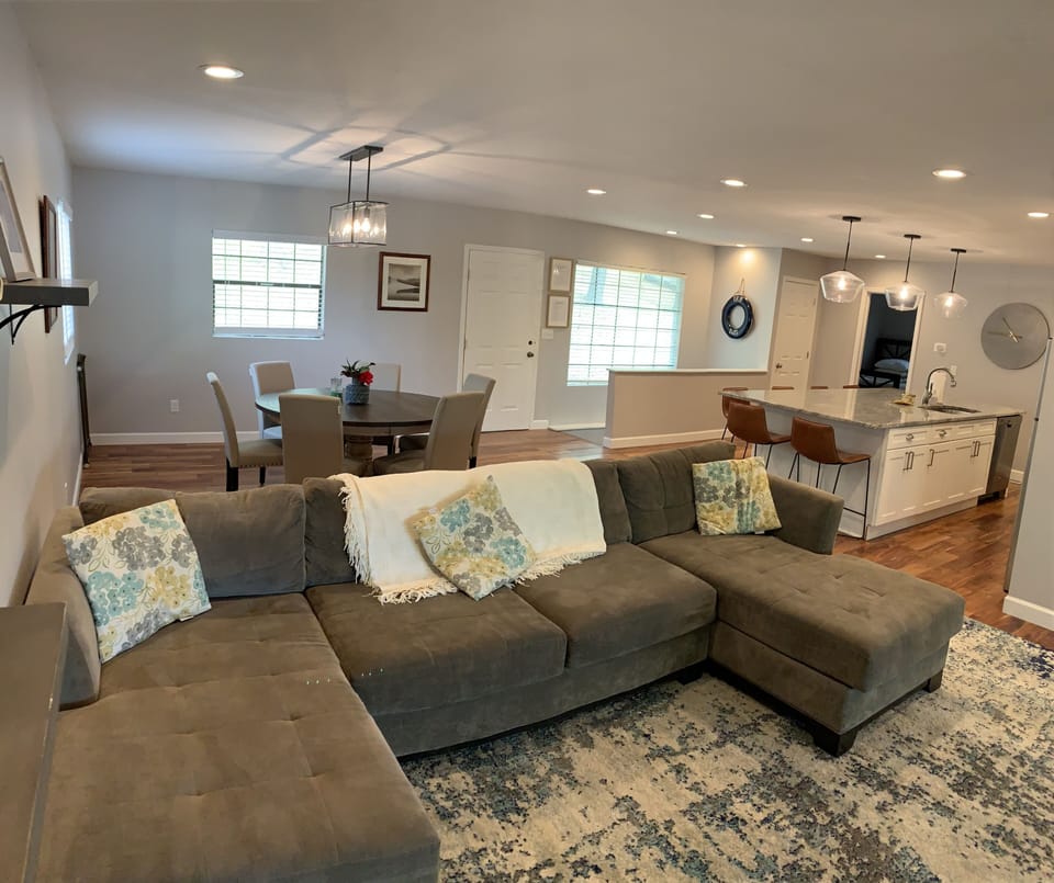 One of three large couches with a TV 