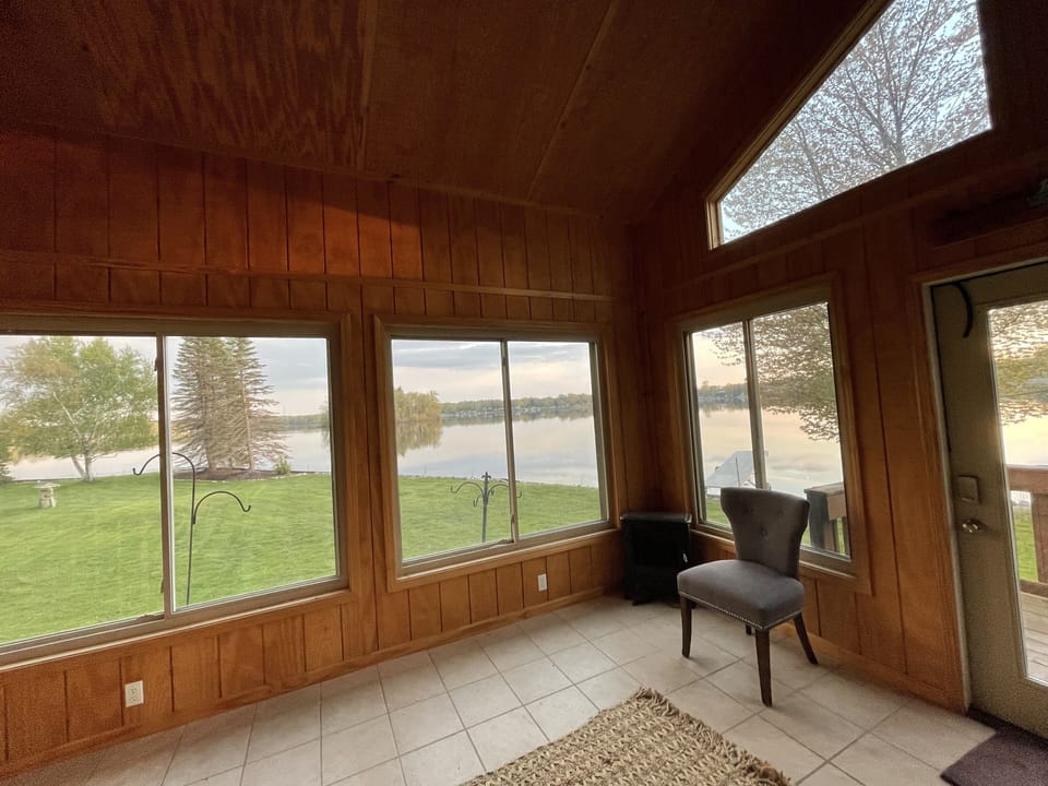 Screened Summer room with plenty of lake view windows 