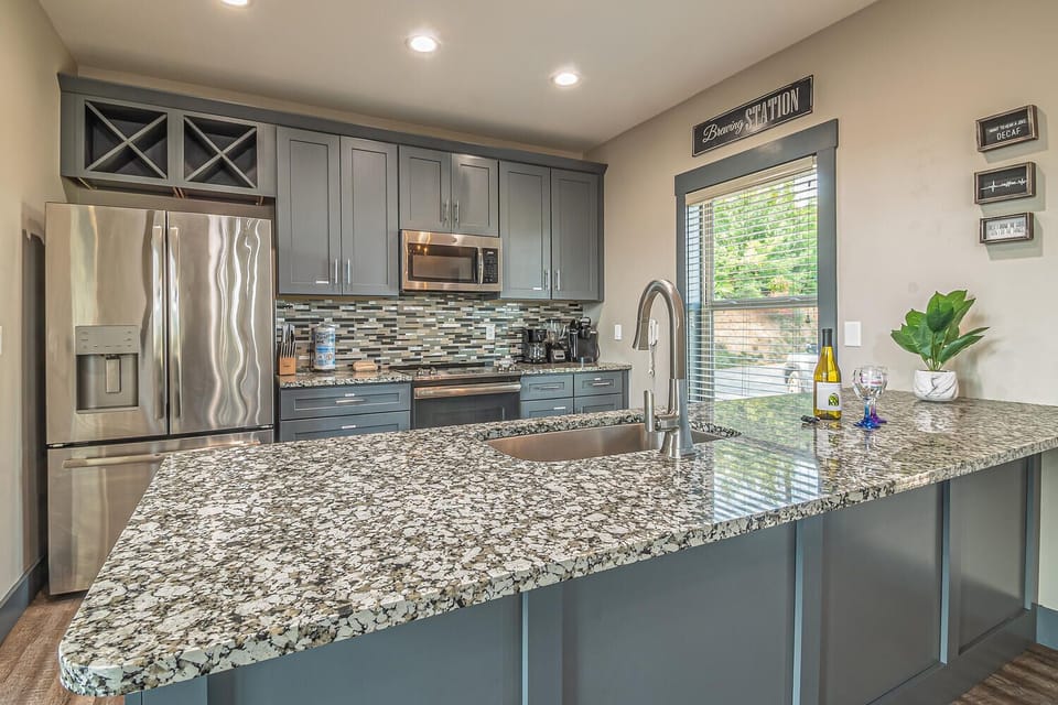Nice Modern Kitchen with Stainless Steel Appliances stocked with pots and pans