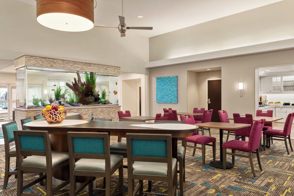 Gather for breakfast and laughs beneath airy, modern lighting.