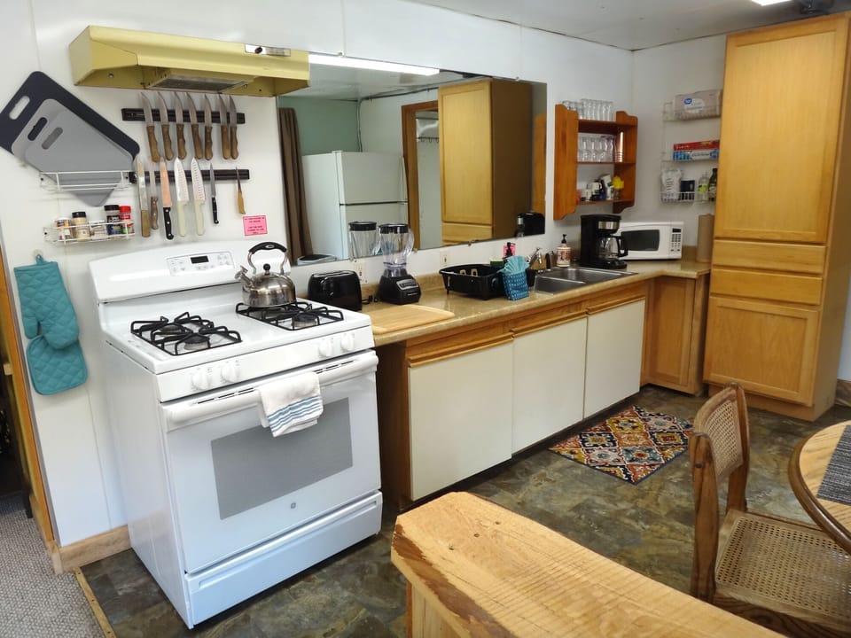 The kitchen has a gas range, toaster, blender, coffee pot & microwave.