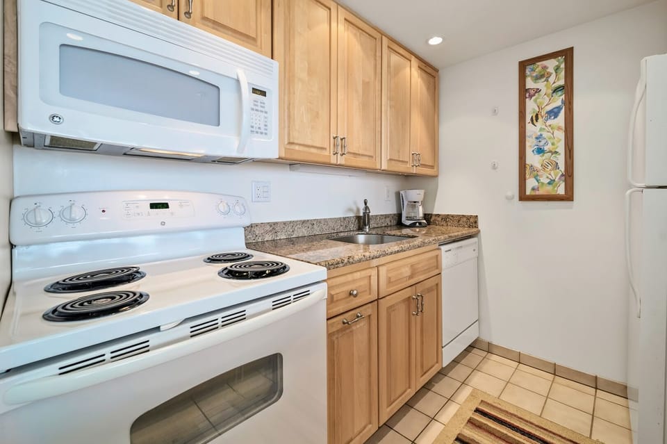 Upgraded unit with granite counter tops and glass back splash.