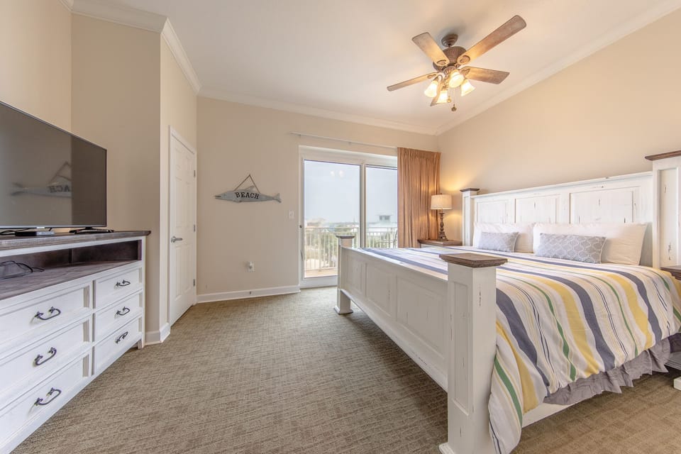 4th bedroom with a king size bed and private balcony.