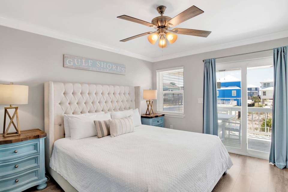 The primary bedroom offers balcony access and private, attached bathroom