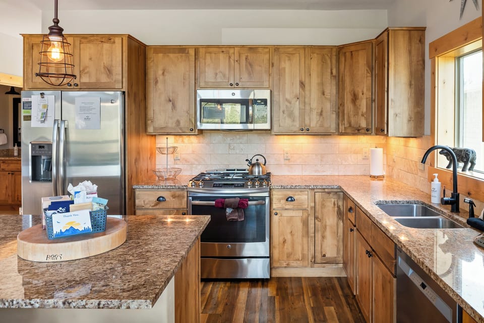 - Fully equipped kitchen with stainless steel appliances and granite counters   - Rustic wood cabinetry enhances warm mountain cabin charm   - Ideal for home cooking during Colorado vacation stays