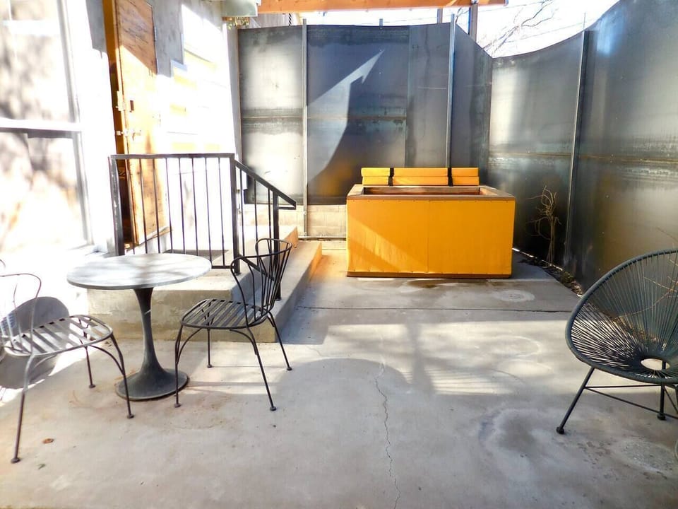 Private patio area with hot water soaking tub, jetless, wooden, in the style of a japanese ofuro