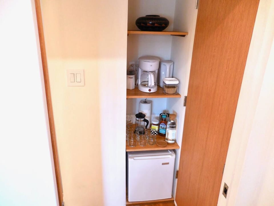 Coffee making area. Coffee maker, electric kettle, coffee grinder, whole bean coffee, tea selection, sweeteners, milk, yogurt, granola, and sparkling water provided. 
